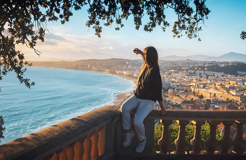 A Person Enjoying a Scenic View of the Coastline and City