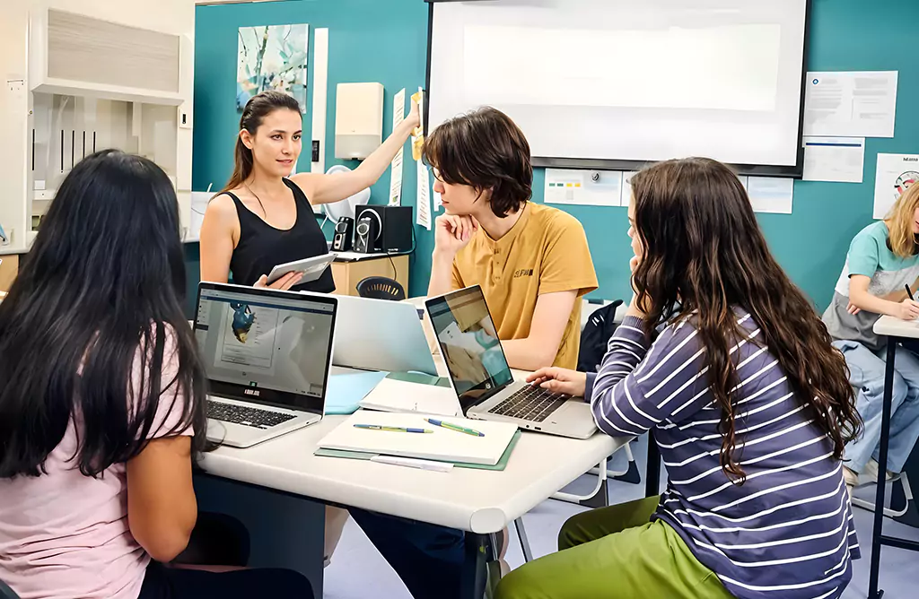 Students Collaborating with a Teacher in a Classroom