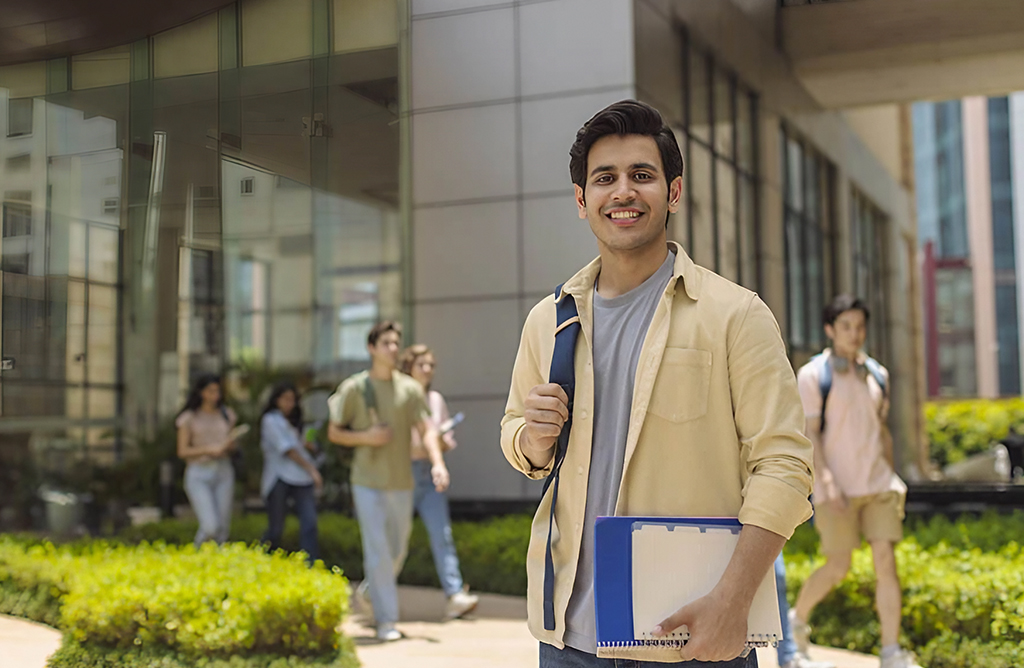 Smiling Student Standing on Modern Campus