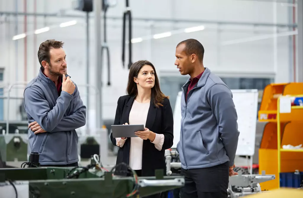 Engineers and Manager Discussing Project in a Factory