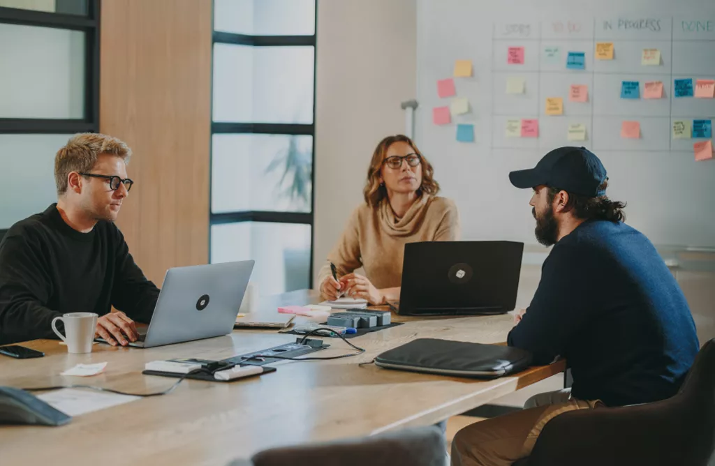 Team Discussion in a Modern Office with Laptops