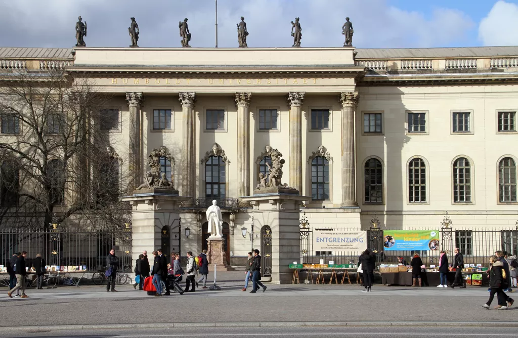 Historic University Building with Students Walking Outside