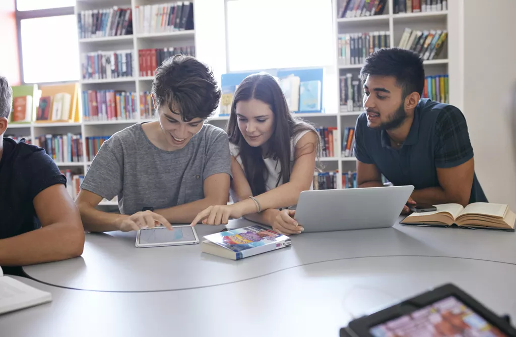 Students Studying Together Using Tablets in a Library