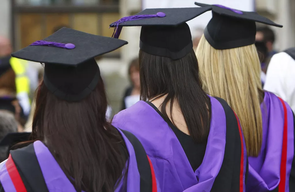 Students Wearing Graduation Gowns and Caps during a Ceremony