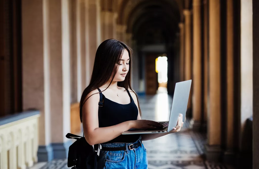 International Student using Laptop on University Campus