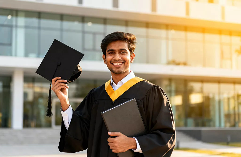 Happy International Student Celebrating Graduation with Cap and Degree