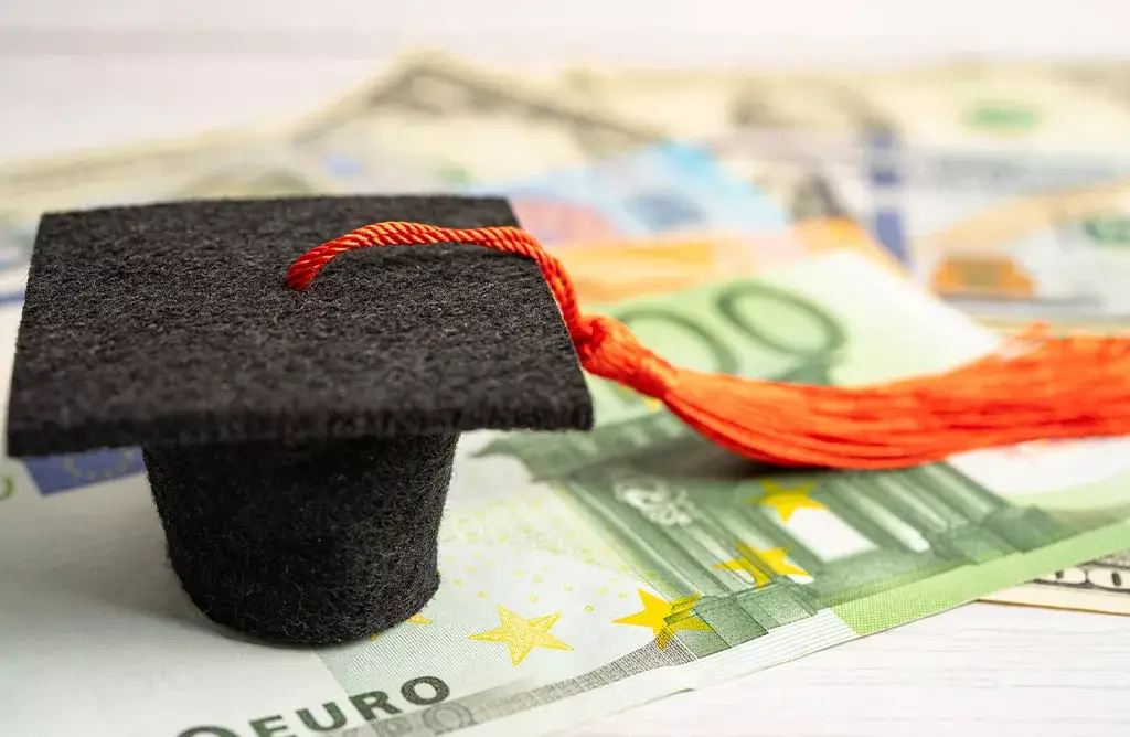 Graduation Cap And Euros Representing The Cost Of Studying a Master's In Europe