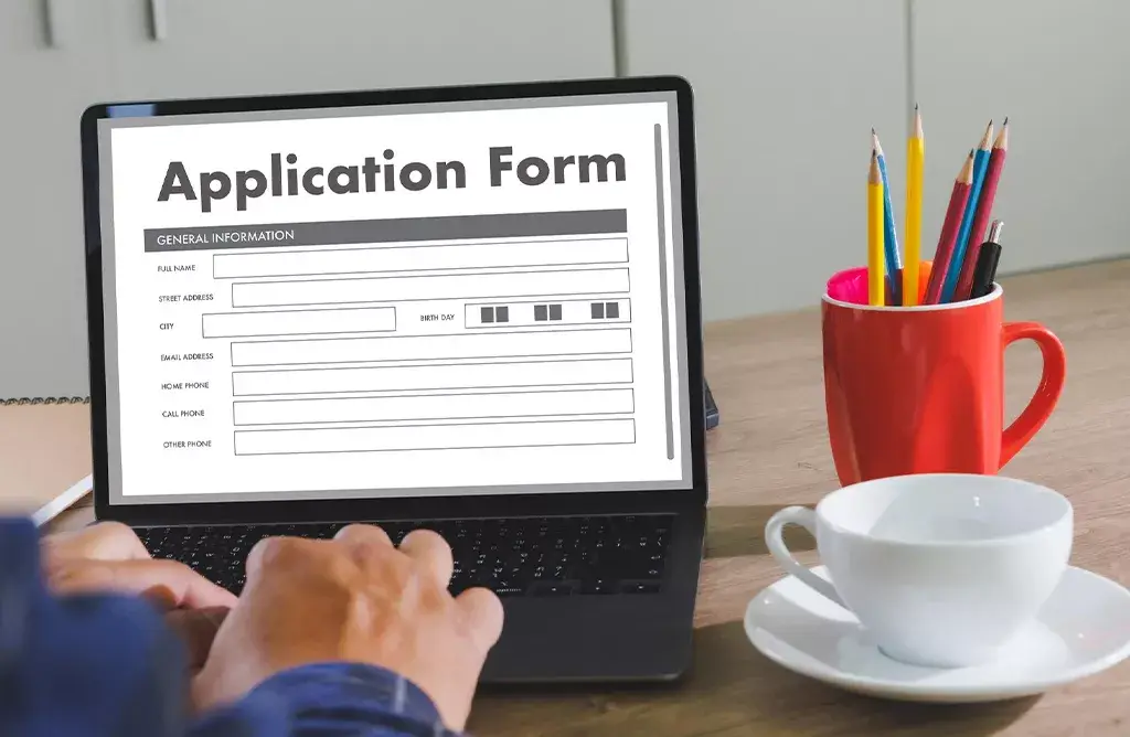Student Completing A University Application Form For Studying In Sweden